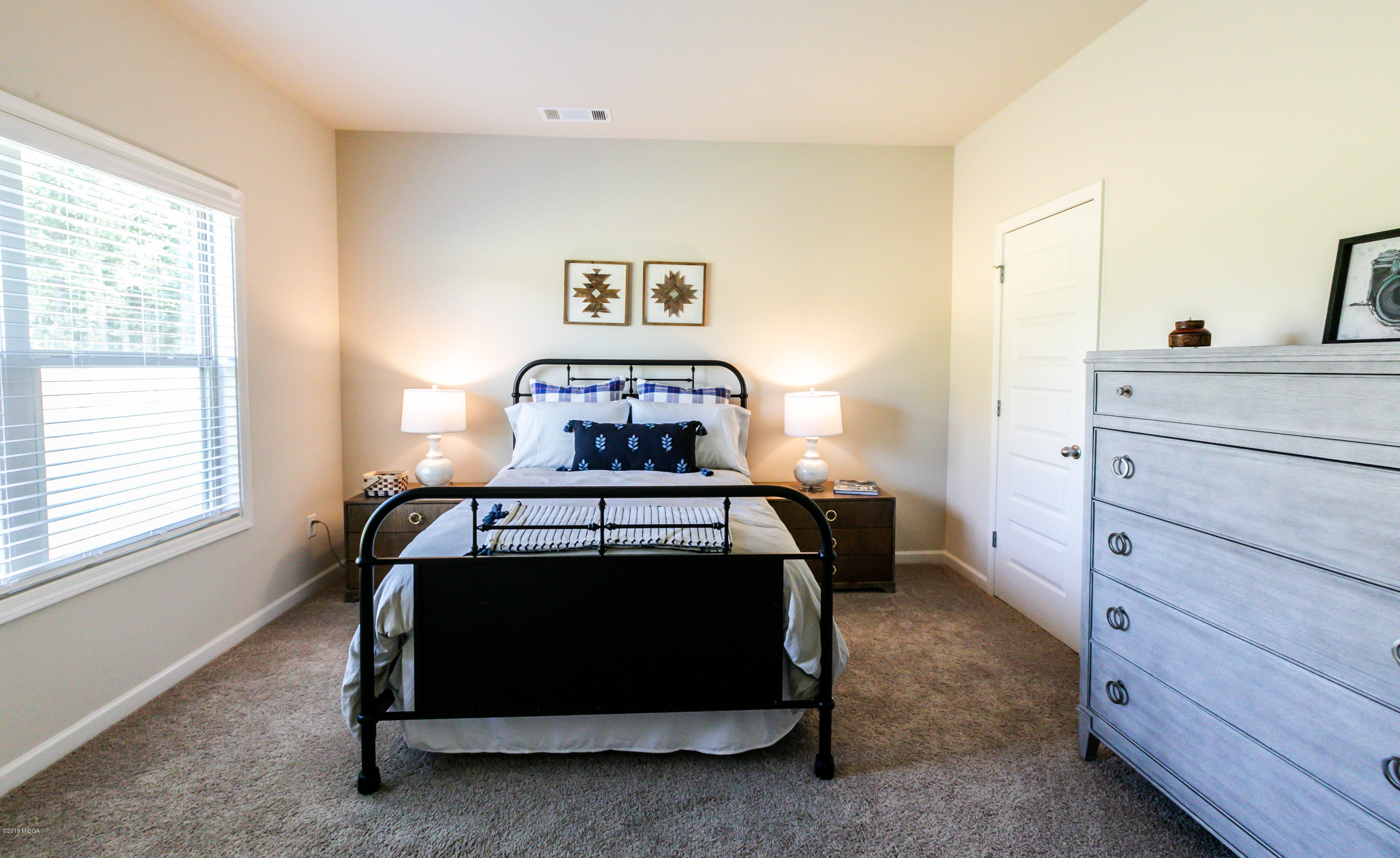 160 Homestead Circle Forsyth, GA 31029 - Photo 16 of 40 a bedroom with a bed and a window
