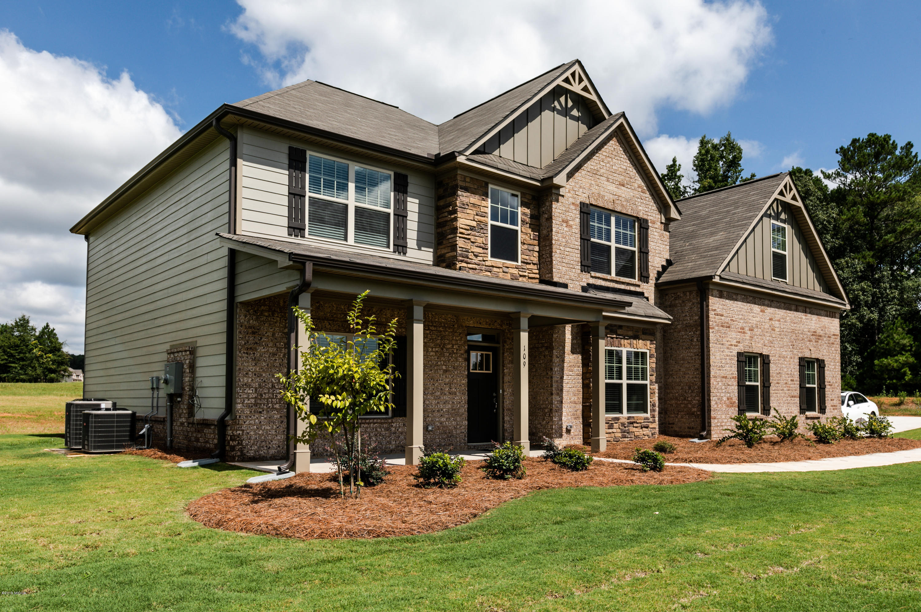 160 Homestead Circle Forsyth, GA 31029 - Photo 3 of 40 a view of a house with backyard porch and sitting area
