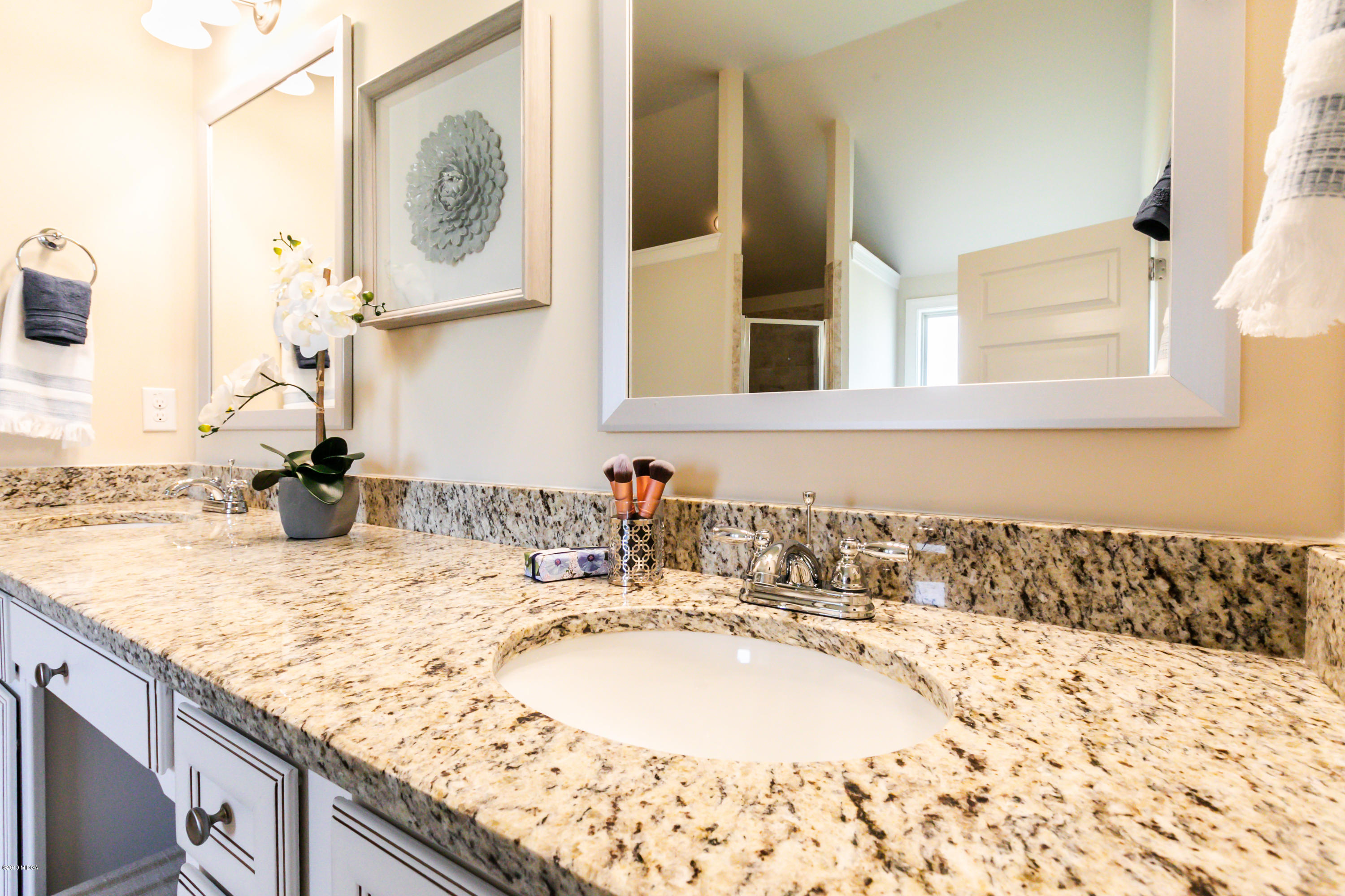 160 Homestead Circle Forsyth, GA 31029 - Photo 25 of 40 a bathroom with a granite countertop sink and a mirror