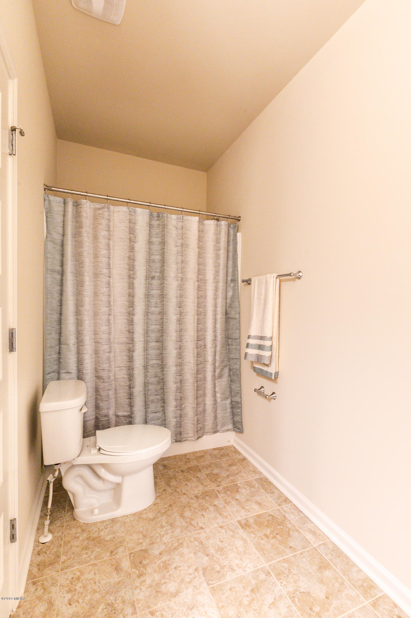 160 Homestead Circle Forsyth, GA 31029 - Photo 35 of 40 a bathroom with a toilet a sink and a window