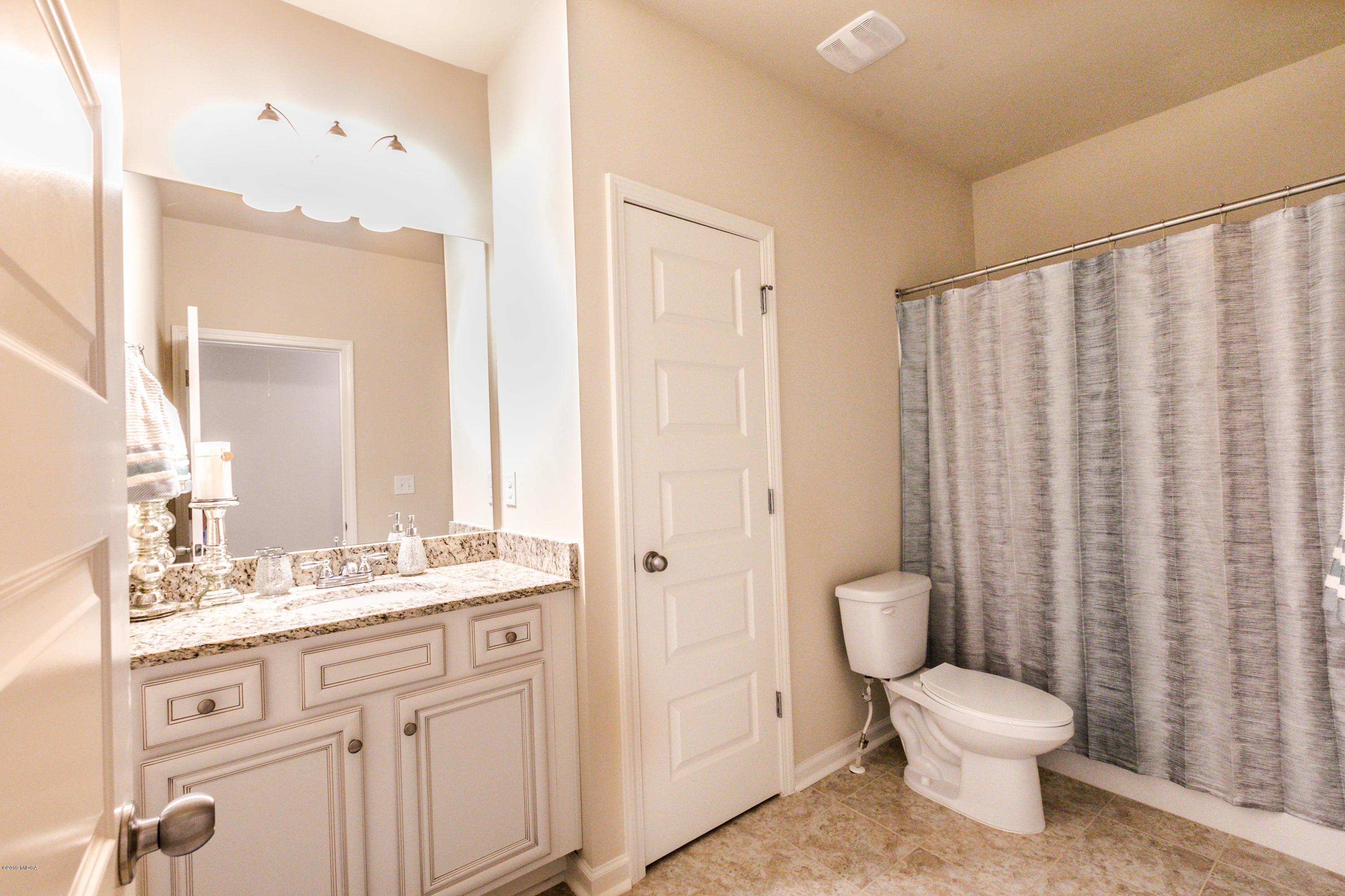 160 Homestead Circle Forsyth, GA 31029 - Photo 36 of 40 a bathroom with a toilet a sink and a mirror