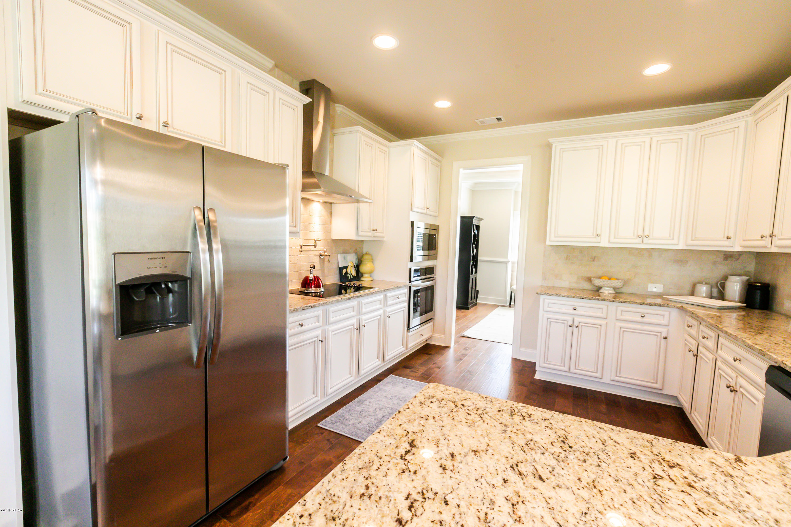 160 Homestead Circle Forsyth, GA 31029 - Photo 7 of 40 a large kitchen with stainless steel appliances kitchen island granite countertop a refrigerator and a sink
