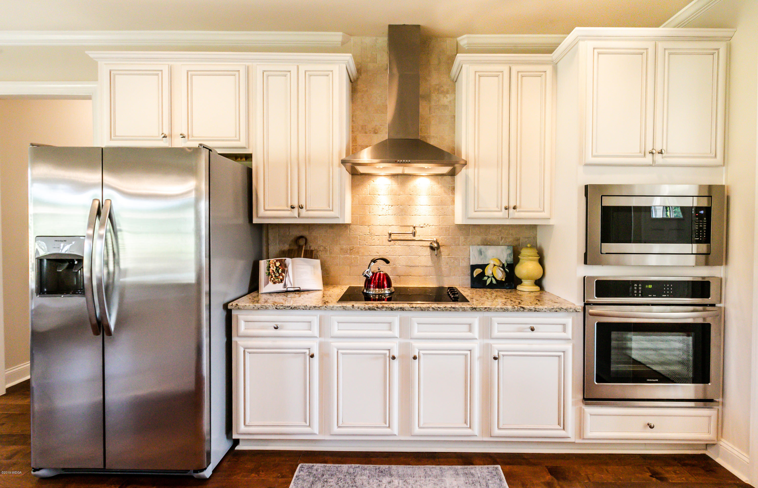 160 Homestead Circle Forsyth, GA 31029 - Photo 9 of 40 a kitchen with white cabinets and stainless steel appliances
