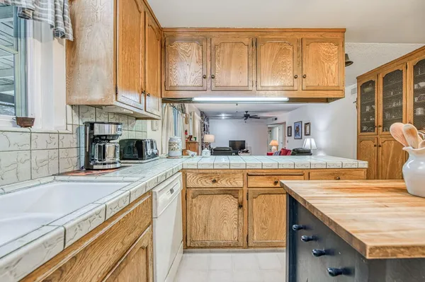 a kitchen with stainless steel appliances granite countertop a sink and cabinets