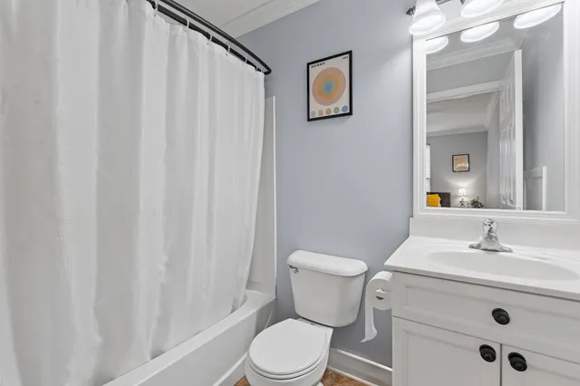a bathroom with a sink a toilet and shower curtain
