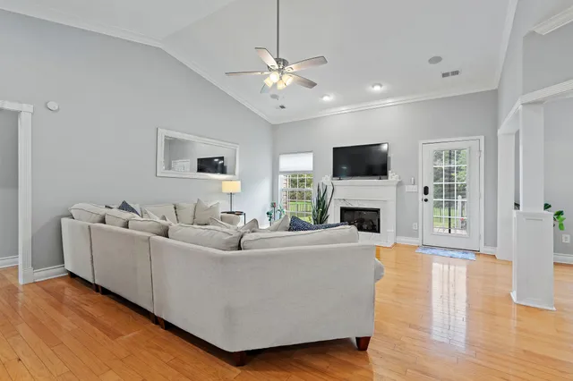 a living room with furniture a fireplace and a flat screen tv