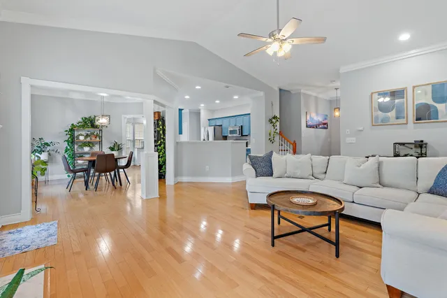 a living room with furniture and kitchen view