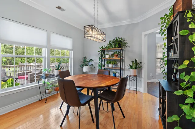 a view of a dining room with furniture window and wooden floor