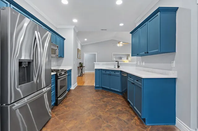 a kitchen with stainless steel appliances granite countertop a refrigerator and a sink