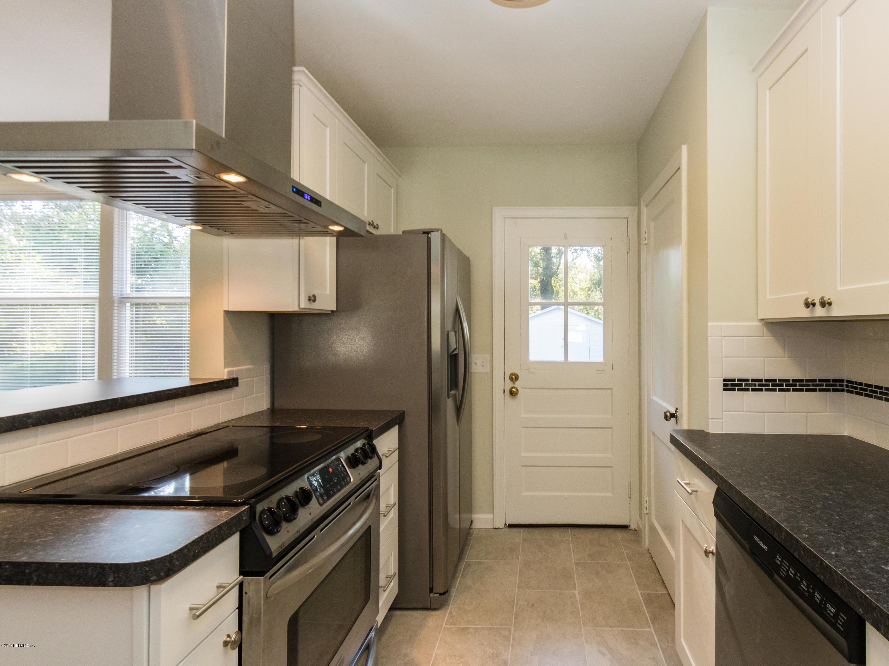 1764 Planters Road Jacksonville, FL 32207 - Photo 13 of 24 a kitchen with stainless steel appliances granite countertop a stove and a refrigerator