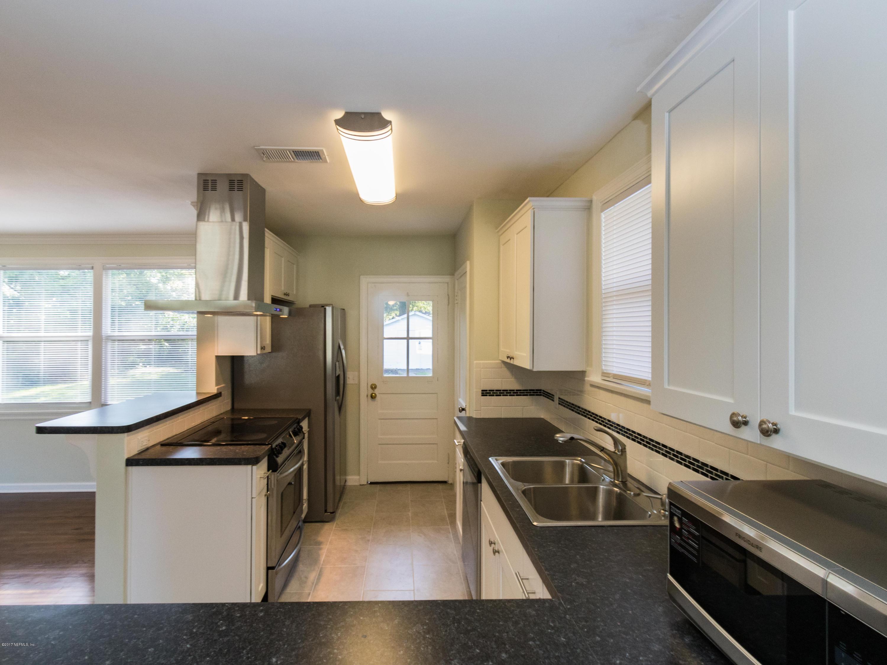 1764 Planters Road Jacksonville, FL 32207 - Photo 14 of 24 a kitchen with a sink appliances and cabinets