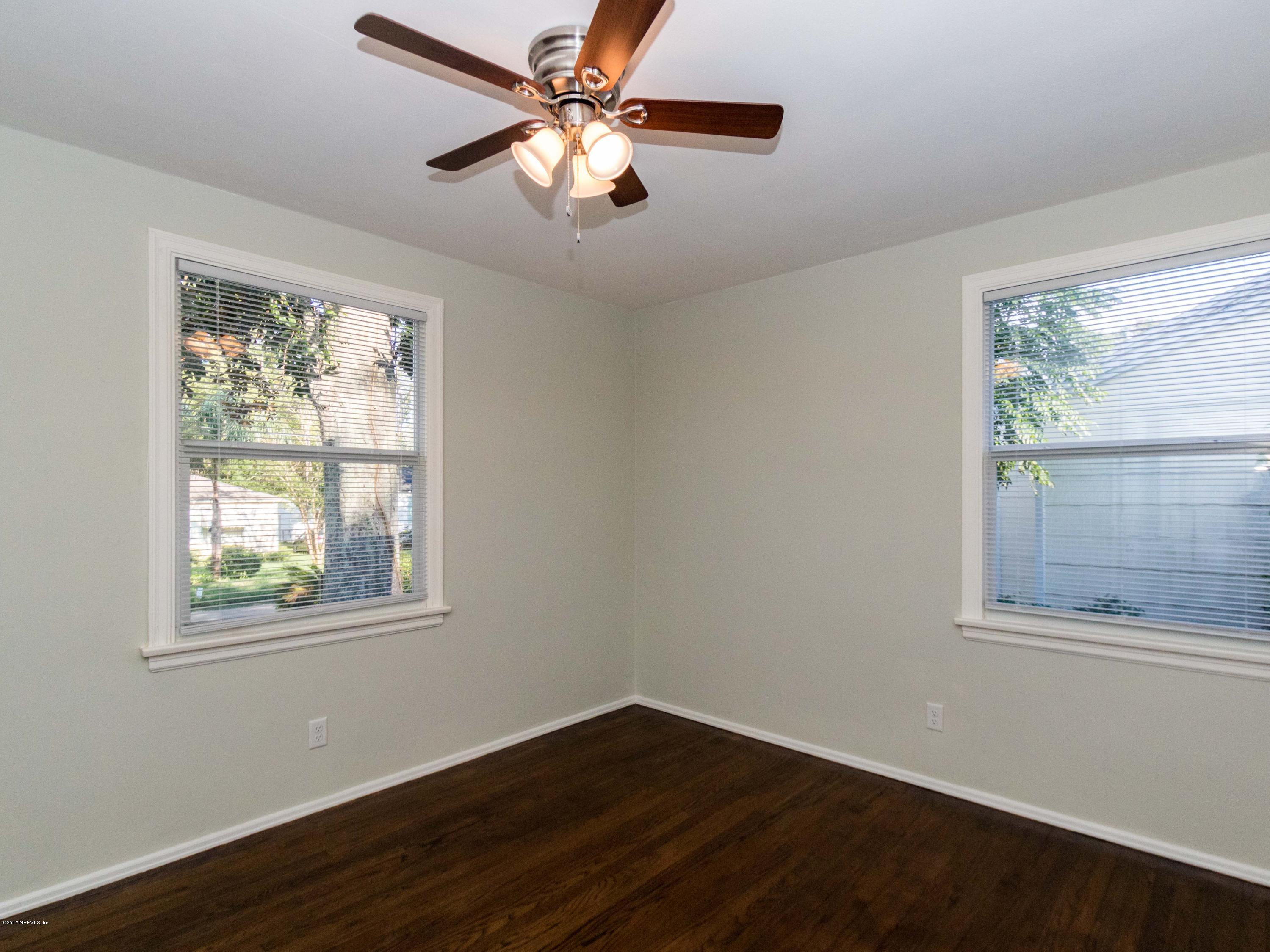 1764 Planters Road Jacksonville, FL 32207 - Photo 17 of 24 a view of an empty room with wooden floor and a window