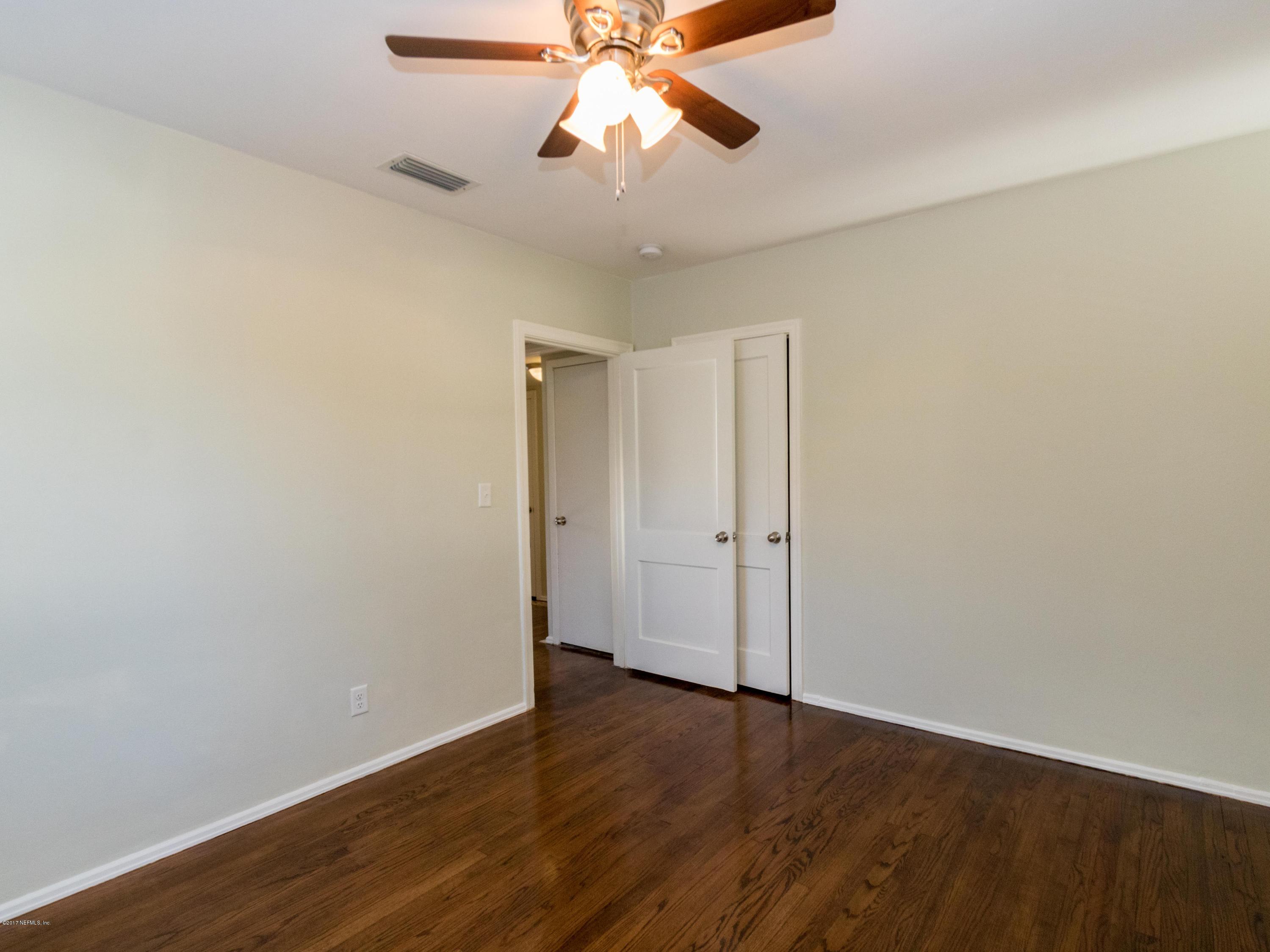 1764 Planters Road Jacksonville, FL 32207 - Photo 18 of 24 a view of an empty room and window and wooden floor