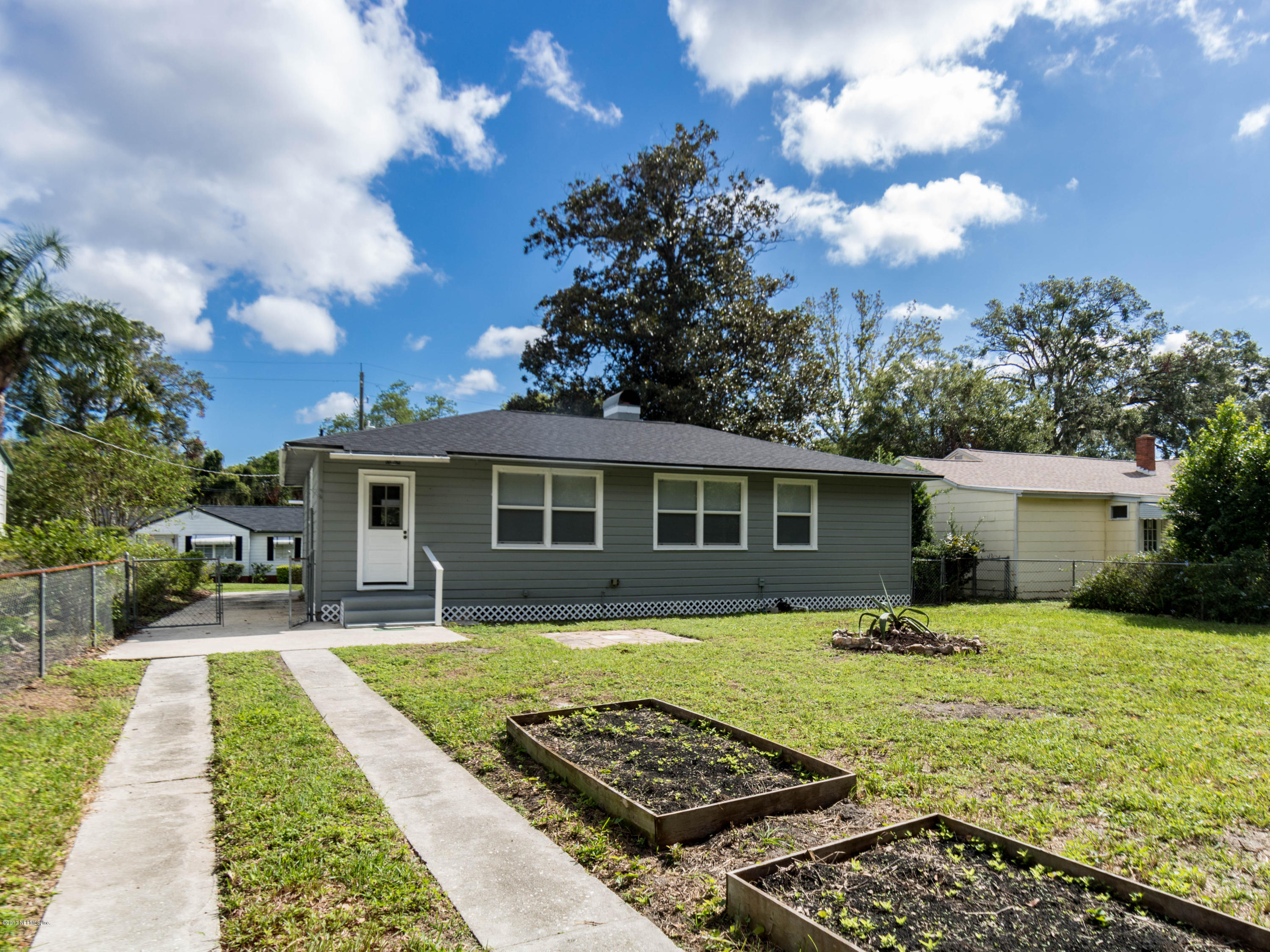 1764 Planters Road Jacksonville, FL 32207 - Photo 23 of 24 a front view of a house with a yard