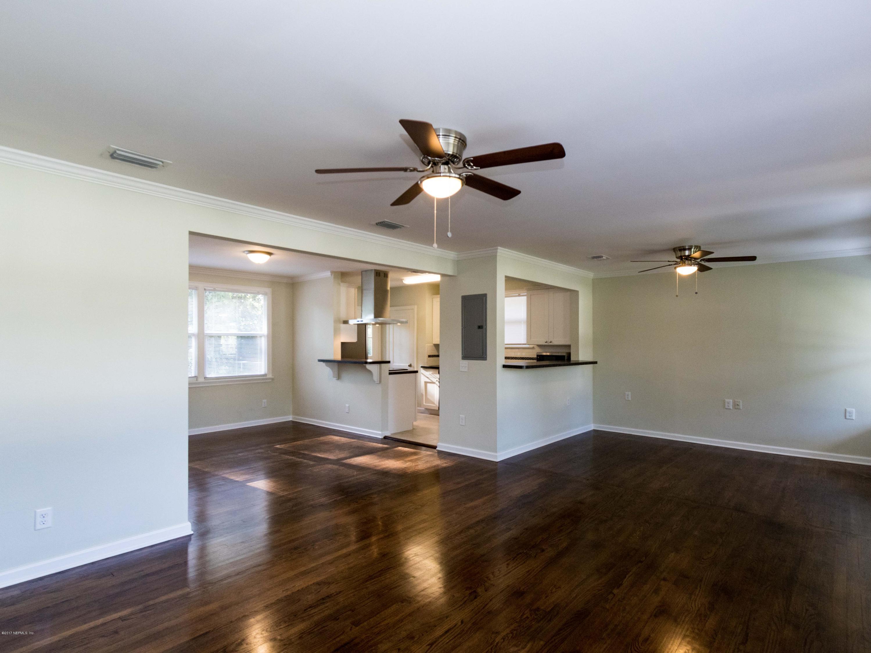 1764 Planters Road Jacksonville, FL 32207 - Photo 7 of 24 a view of a kitchen with wooden floor and a ceiling fan