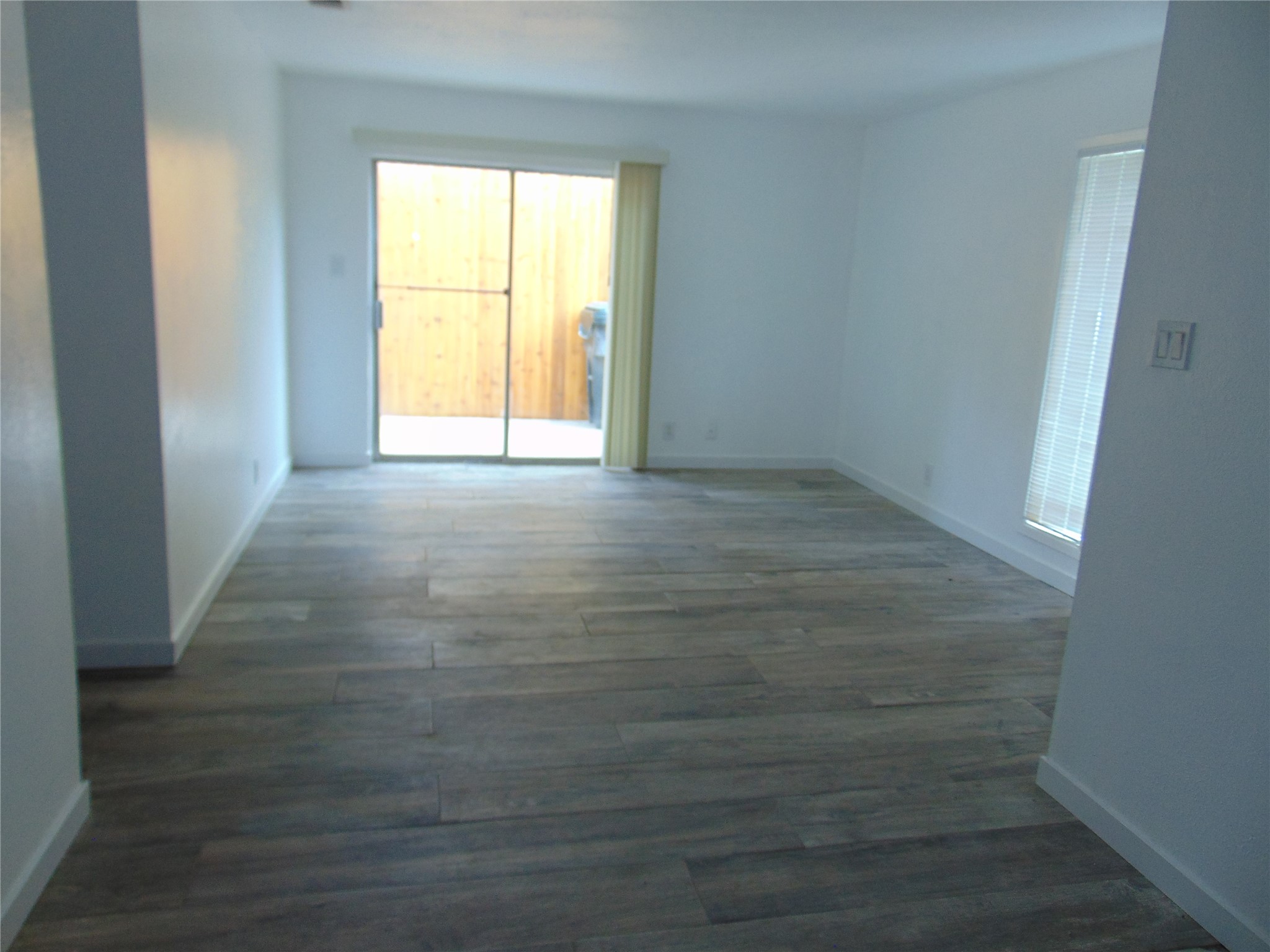 407 Live Oak Street Kyle, TX 78640 - Photo 2 of 9 a view of empty room with wooden floor and fan