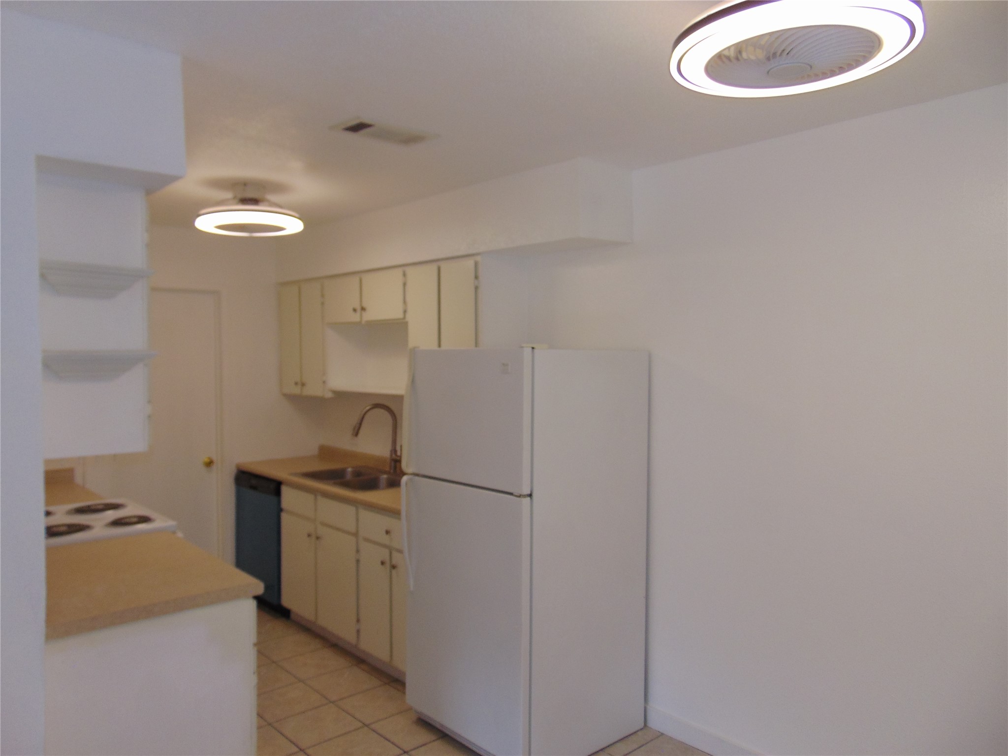 407 Live Oak Street Kyle, TX 78640 - Photo 3 of 9 a kitchen with cabinets and stainless steel appliances