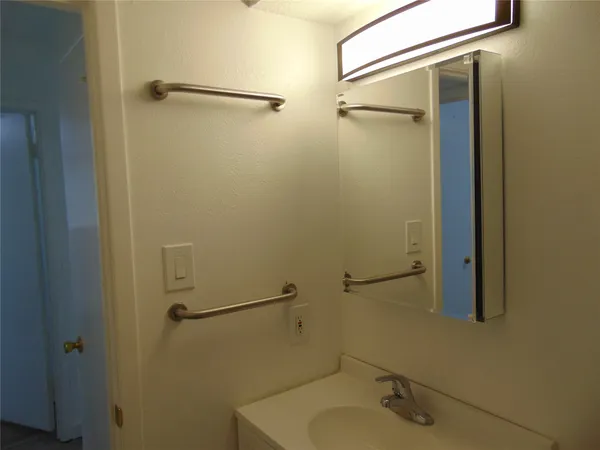 a bathroom with a shower and a sink