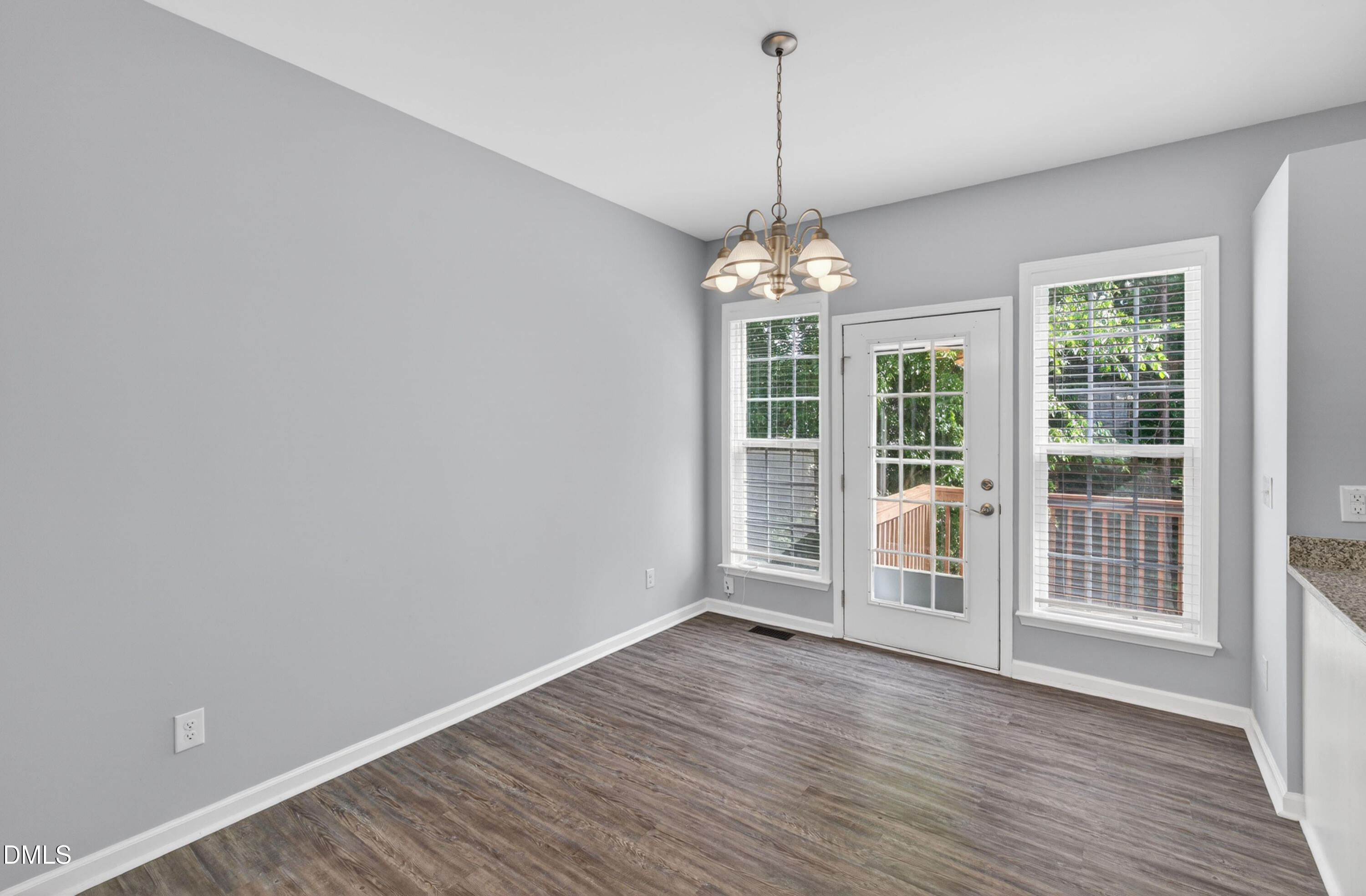 5421 Golden Arrow Lane Raleigh, NC 27613 - Photo 17 of 49 a view of an empty room with wooden floor and a window