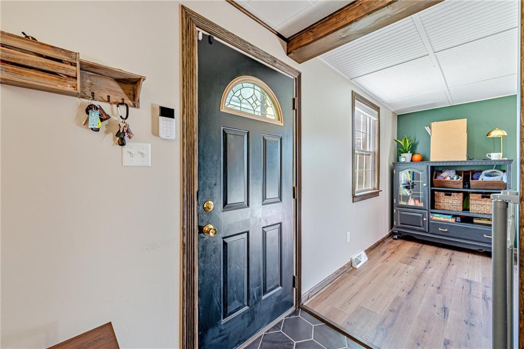 481 Crawford Run Road Cheswick, PA 15024 - Photo 3 of 24 a view of a hallway to a livingroom with furniture and wooden floor