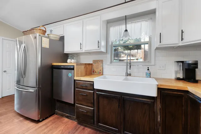 a kitchen with a sink stainless steel appliances and cabinets