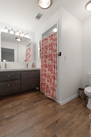 a room with painting on the wall and a sink