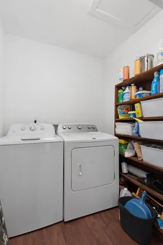 a view of a hallway with wooden floor and a living room