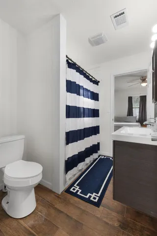 a bedroom with a bed and a tv on the dresser