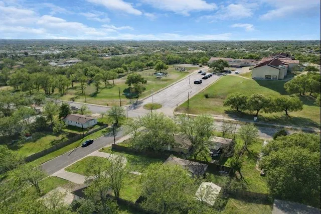 an aerial view of residential houses with outdoor space and river