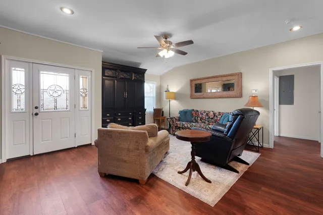 a living room with furniture and a wooden floor