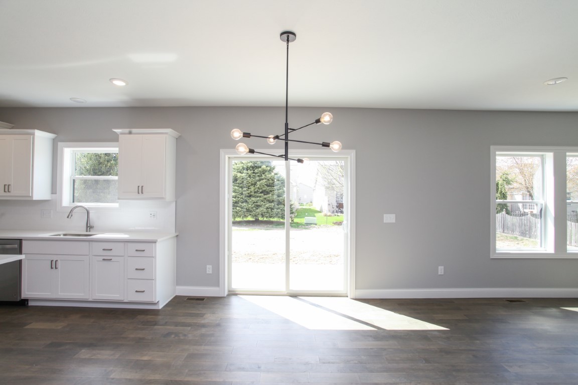 9 Brookstone Circle Bloomington, IL 61704 - Photo 11 of 40 a view of a kitchen with a sink a window and wooden floor