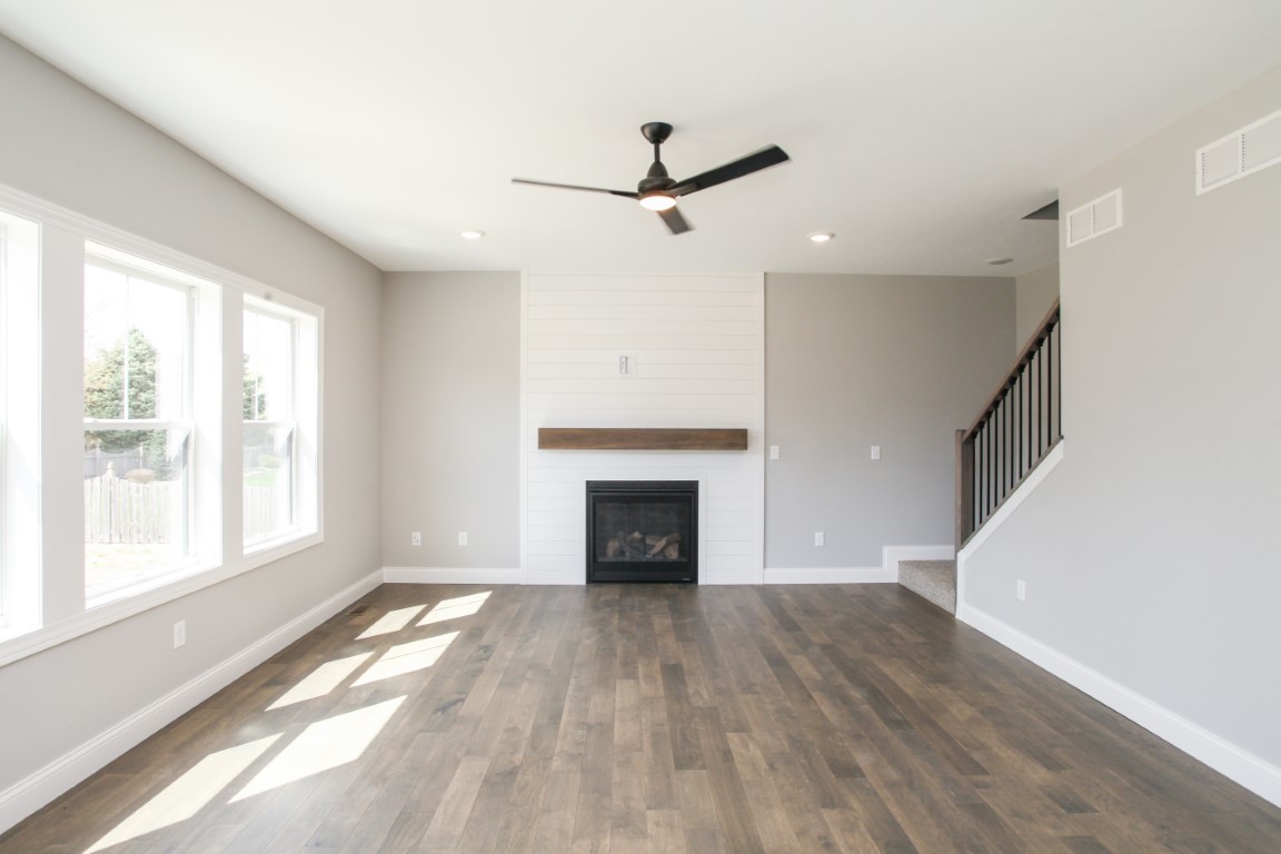 9 Brookstone Circle Bloomington, IL 61704 - Photo 13 of 40 a view of empty room with wooden floor and fireplace