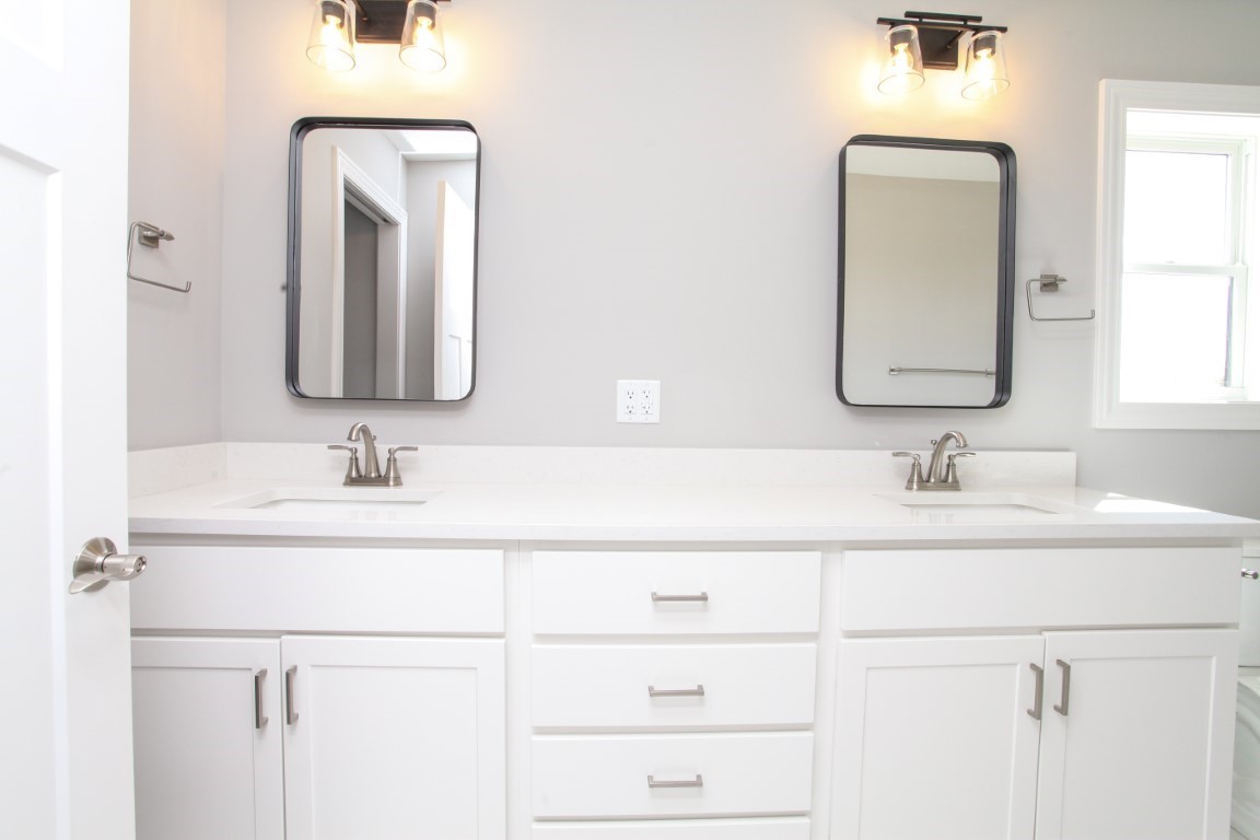9 Brookstone Circle Bloomington, IL 61704 - Photo 25 of 40 a bathroom with a double vanity sink and a mirror