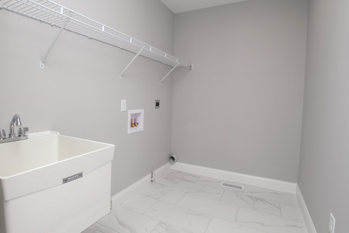 9 Brookstone Circle Bloomington, IL 61704 - Photo 32 of 40 a utility room with a sink dryer and washer