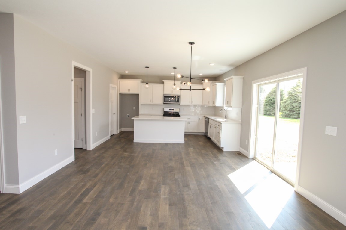 9 Brookstone Circle Bloomington, IL 61704 - Photo 37 of 40 a view of a kitchen with wooden floor and electronic appliances