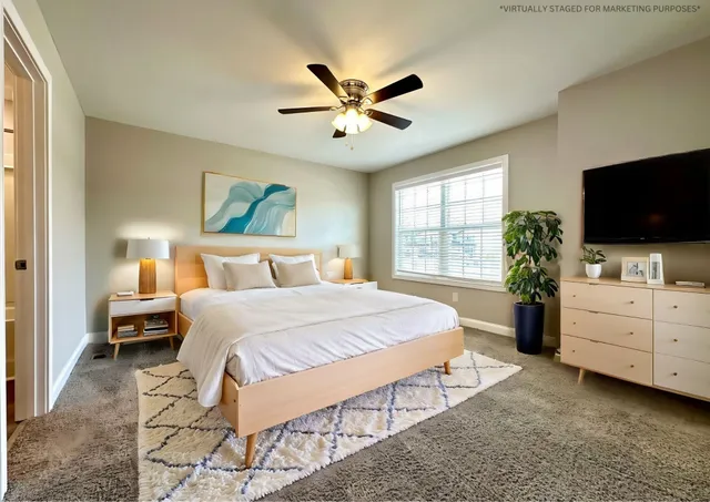 a bedroom with a large bed and a flat screen tv