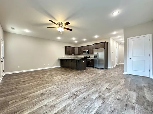 a view of kitchen with refrigerator and windows