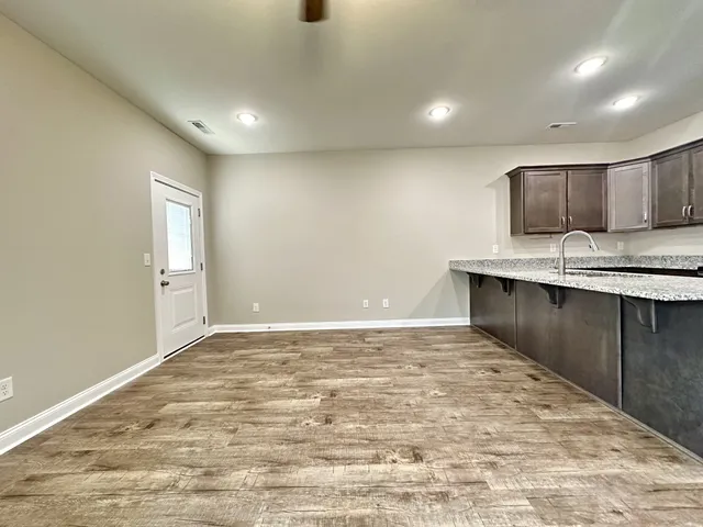 a view of kitchen with kitchen island a sink appliances and a counter top space