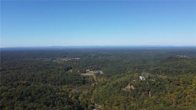 an aerial view of residential houses with city view