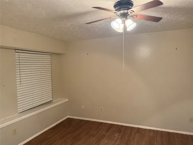 a small space with a chandelier fan and a window