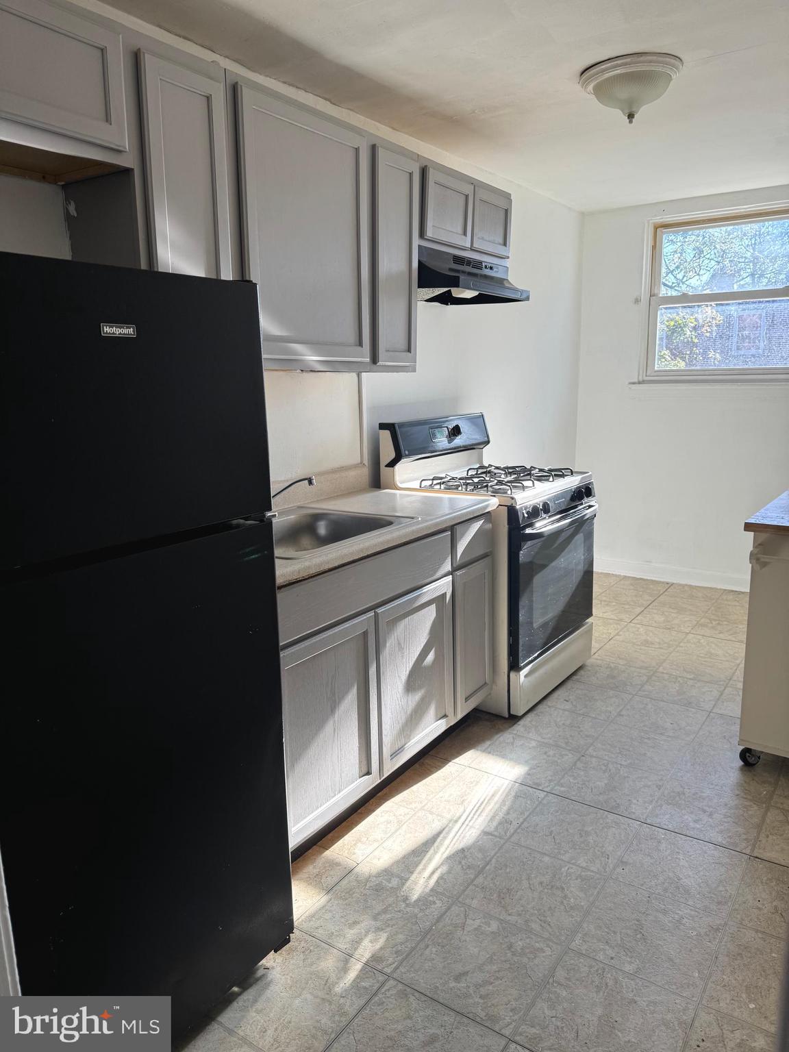 7736 Gilbert Street Philadelphia, PA 19150 - Photo 2 of 13 a kitchen with stainless steel appliances granite countertop a refrigerator a stove a sink and dishwasher