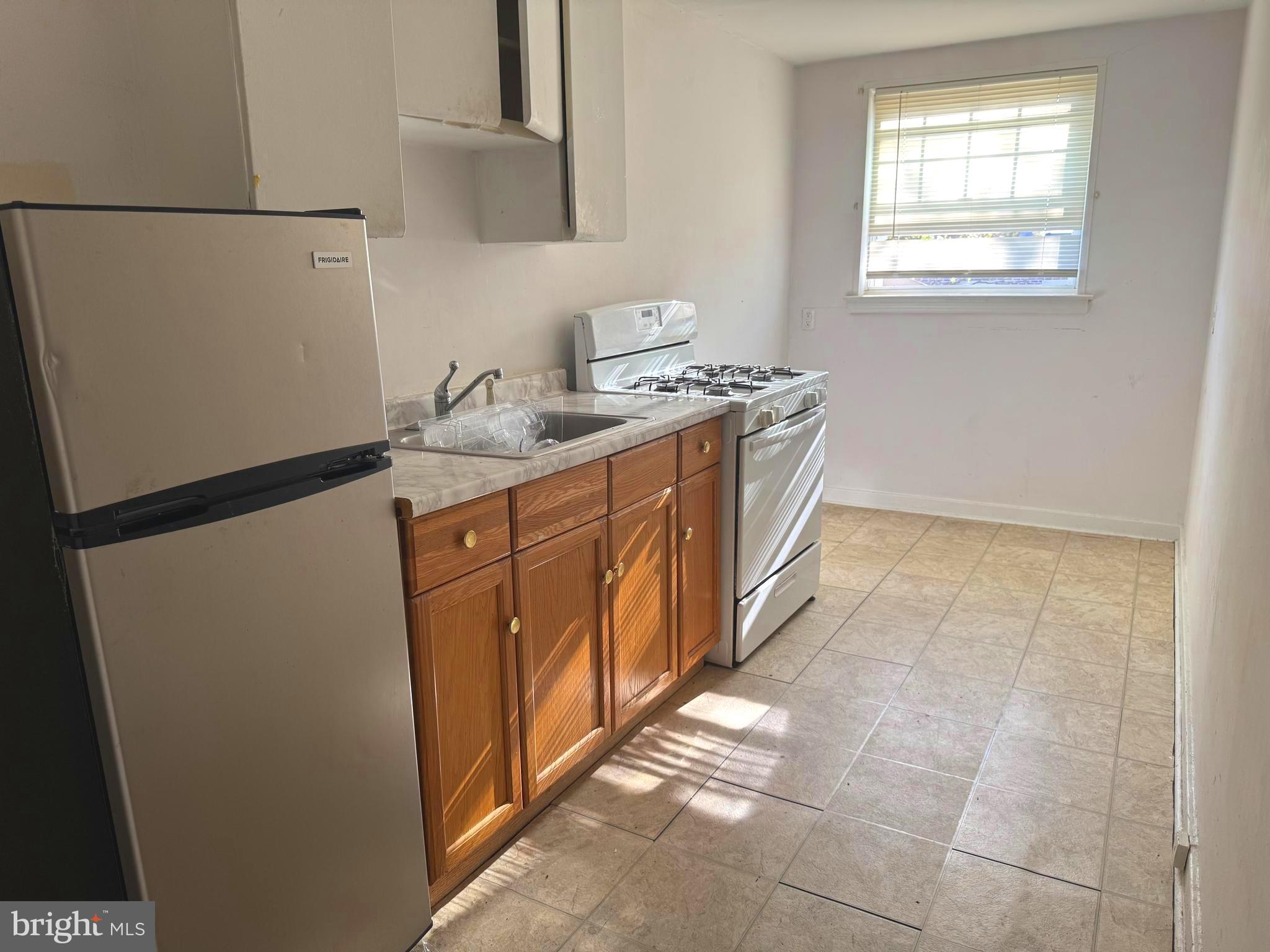 7736 Gilbert Street Philadelphia, PA 19150 - Photo 6 of 13 a utility room with cabinets washer and dryer