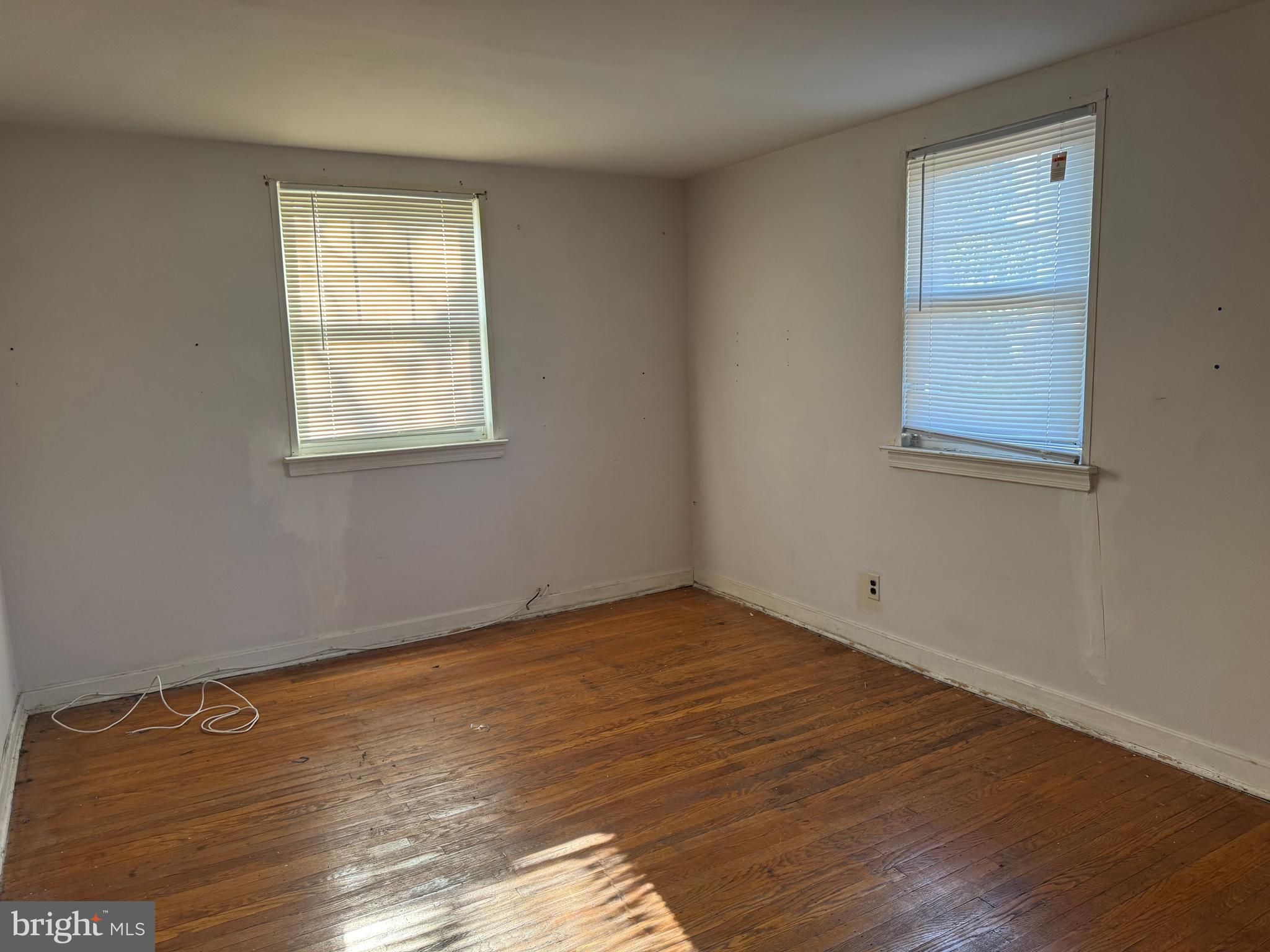 7736 Gilbert Street Philadelphia, PA 19150 - Photo 8 of 13 an empty room with wooden floor and windows