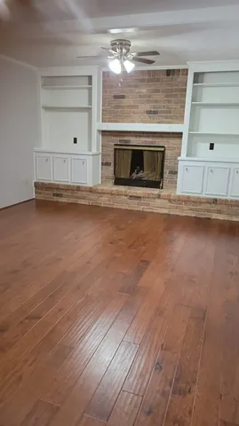 a kitchen with granite countertop a stove and a wooden floor
