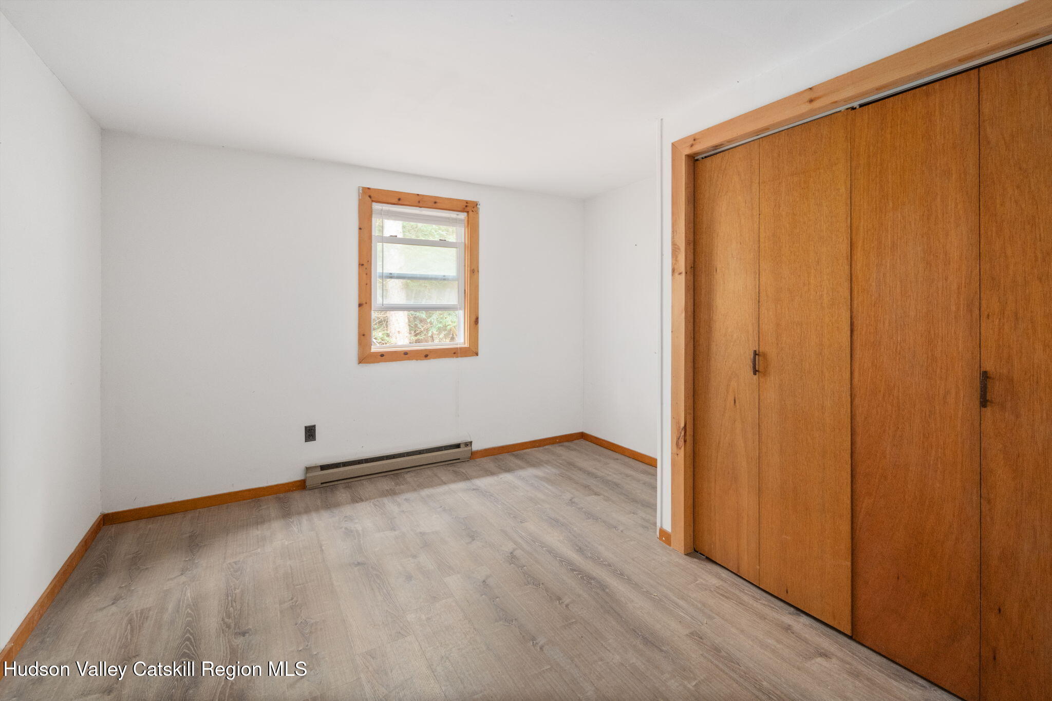 202 Blakesley Road, Unit PRIVATE Gilboa, NY 12076 - Photo 16 of 39 an empty room with wooden floor and windows