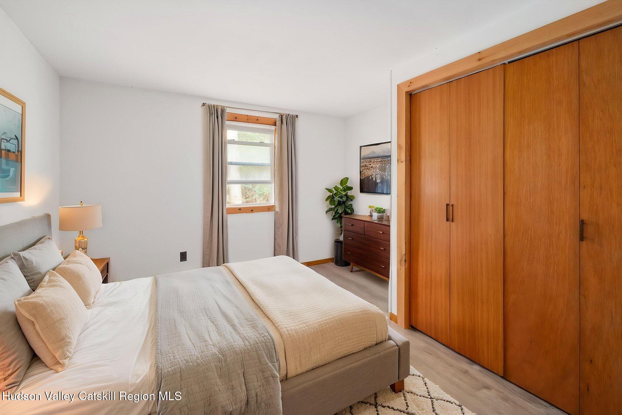 202 Blakesley Road, Unit PRIVATE Gilboa, NY 12076 - Photo 17 of 39 a bedroom with a bed and a window