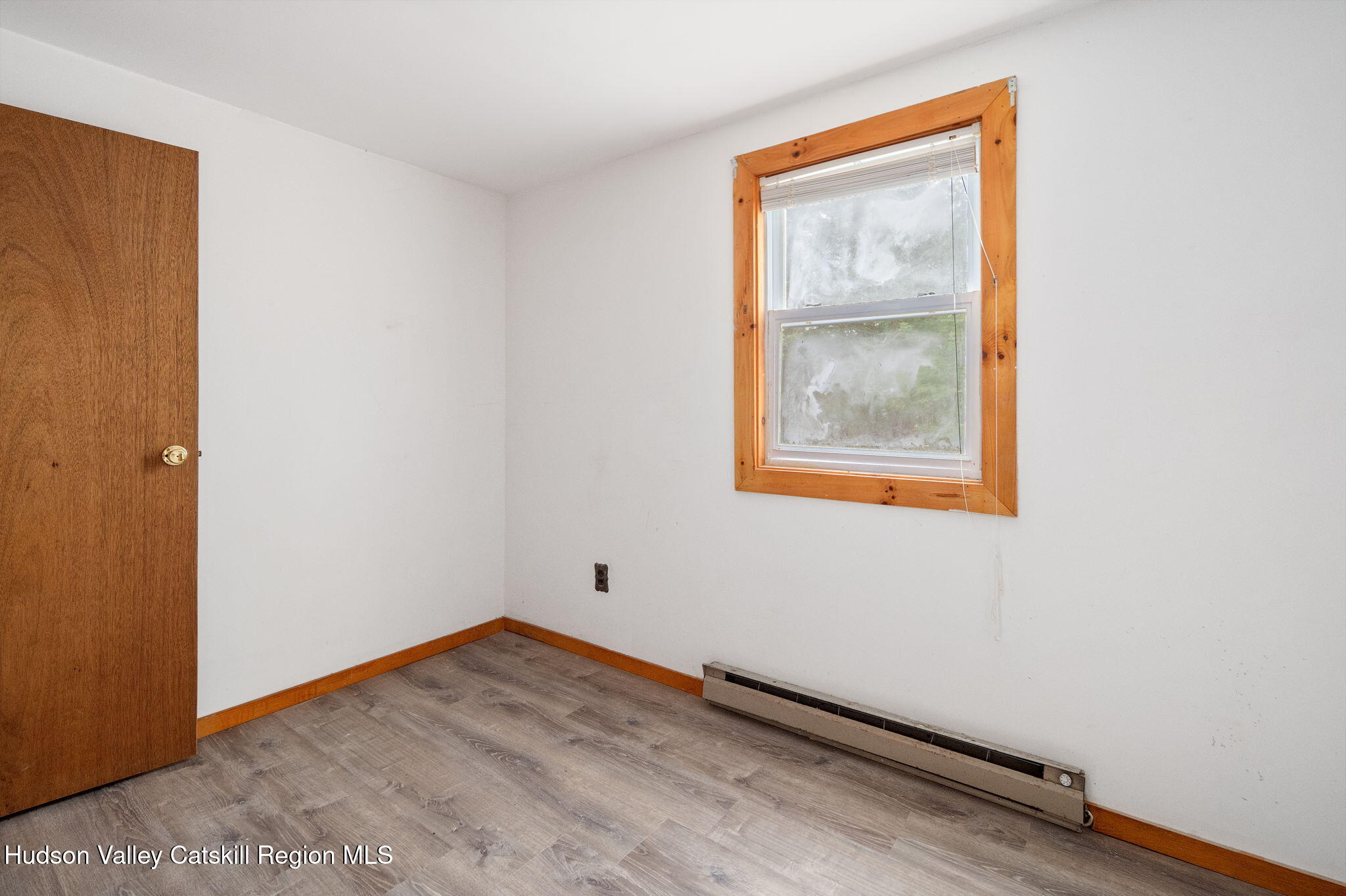 202 Blakesley Road, Unit PRIVATE Gilboa, NY 12076 - Photo 20 of 39 a view of an empty room with wooden floor and a window