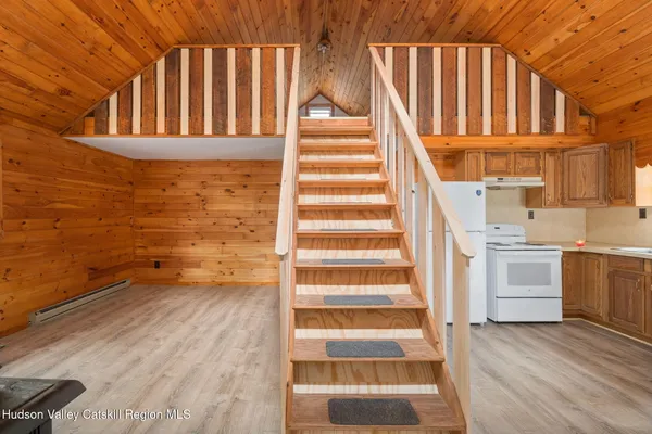 a view of staircase with white walls and a window