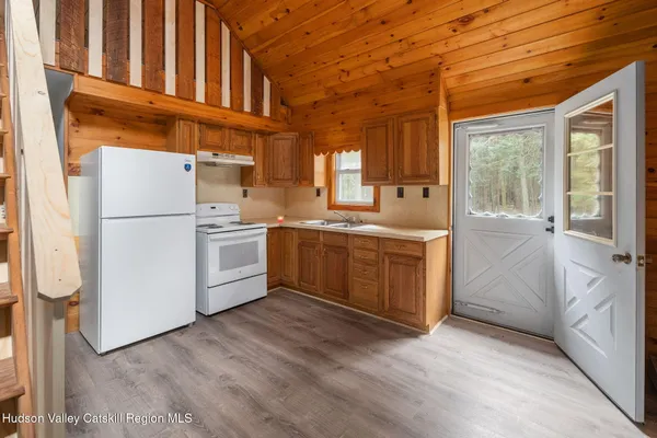 a kitchen with a cabinets and white stainless steel appliances