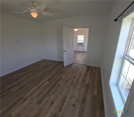 a view of wooden floor and windows in a room